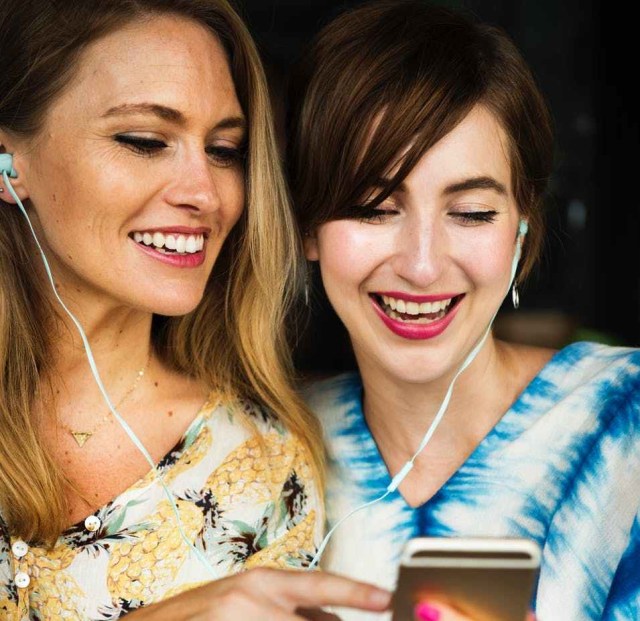 two girls using iphone